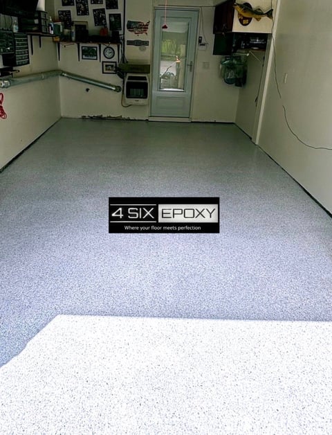 Garage floor with gray and white epoxy coating, displaying 4 SIX EPOXY logo and branding